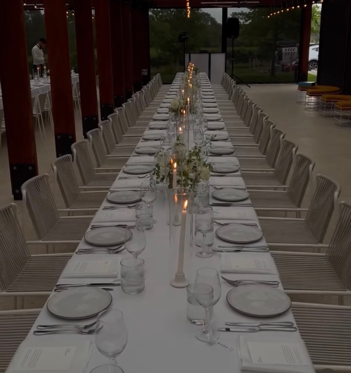 Guests toasting wine at an outdoor celebration in golden-hour light
